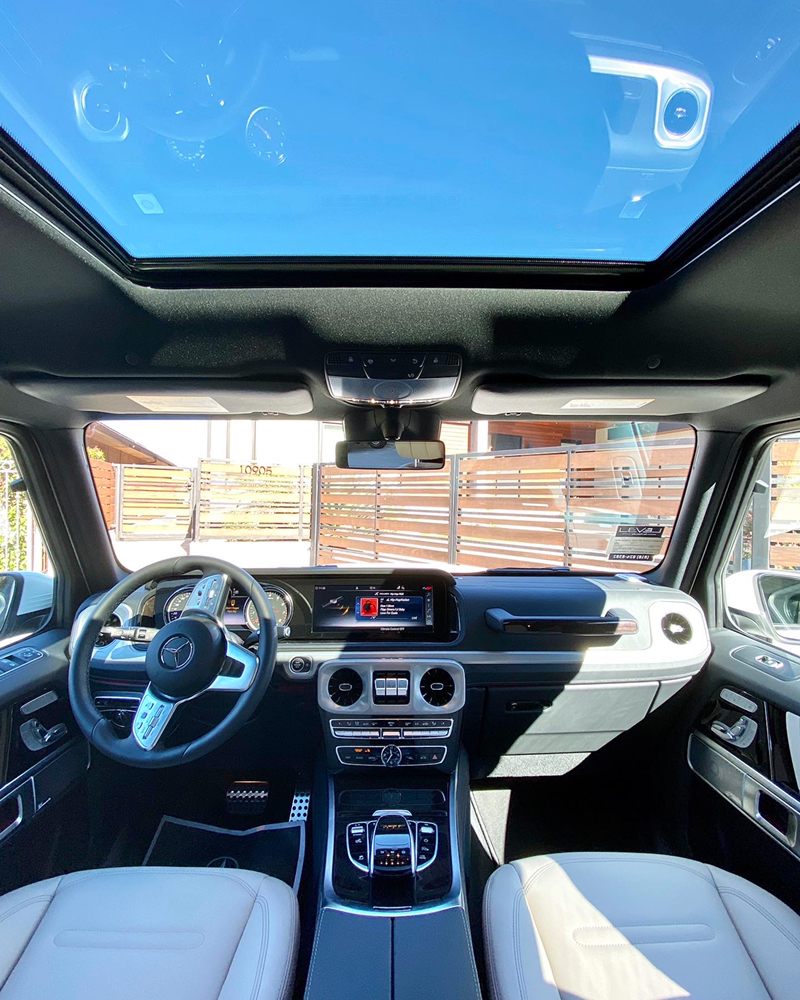 Light leather seats and panoramic roof inside a Mercedes-Benz G-Class