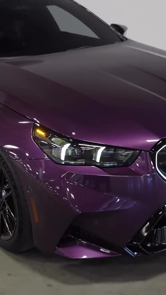 Purple BMW M5 headlight and front quarter photographed by LEVEL